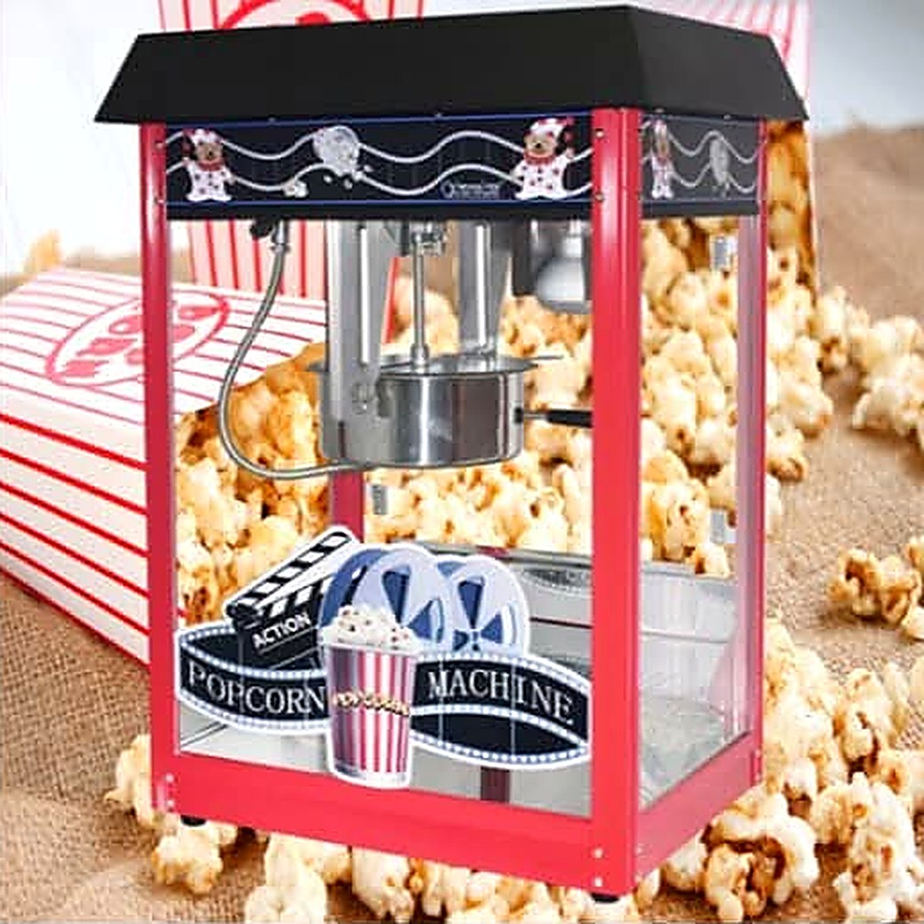 Red and black popcorn machine full of fresh popcorn